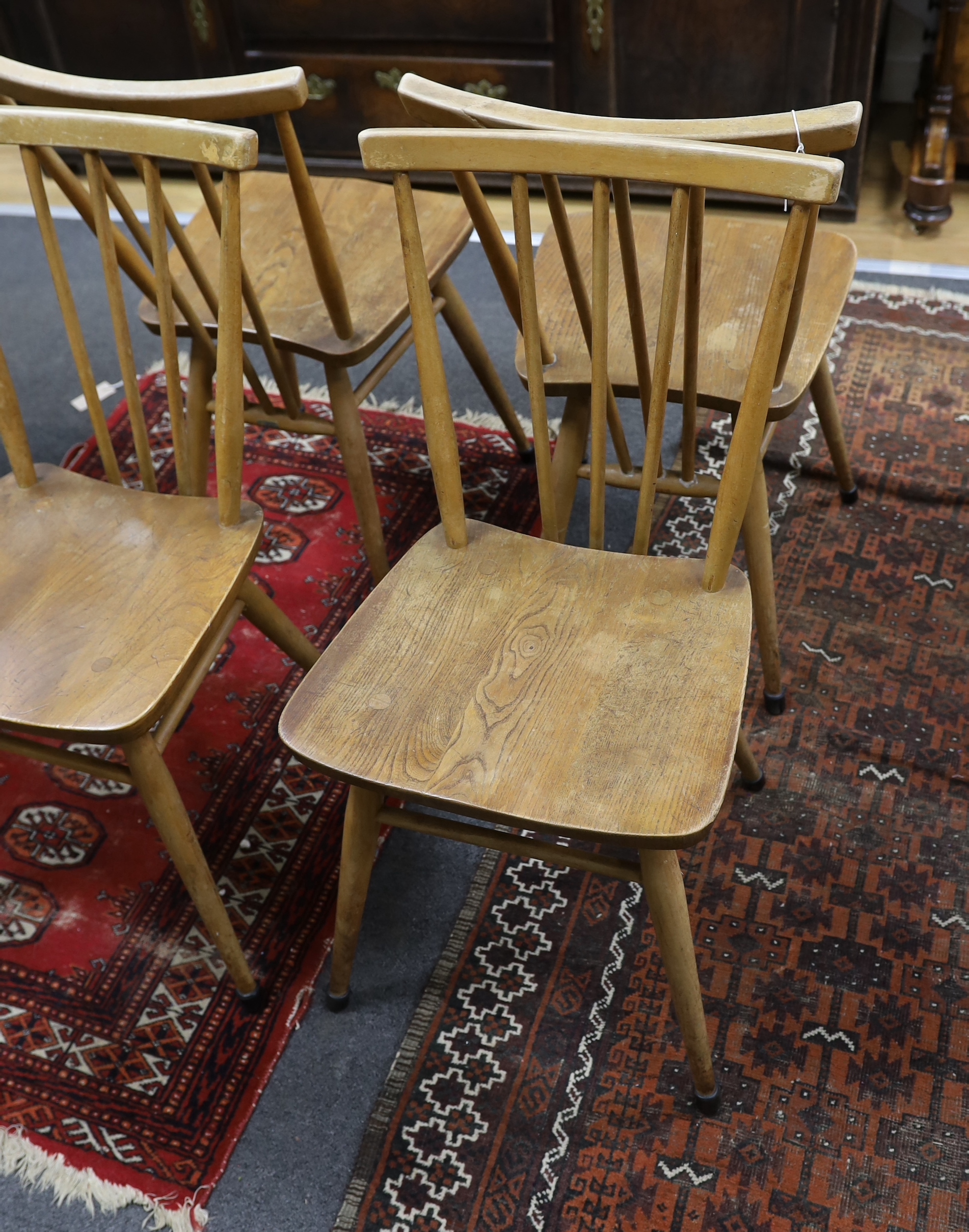 A set of four Ercol elm and beech fan back dining chairs